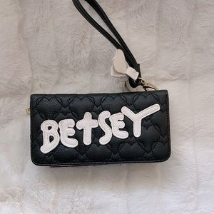 Betsey Johnson clutch stores a lot of cards and zipper back holds more